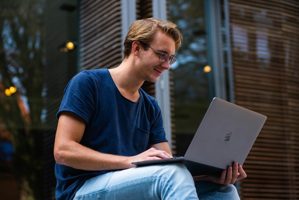 Selective focus photo of man using laptop